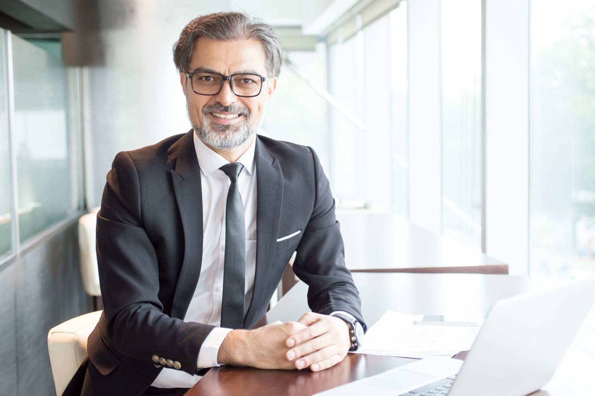 Smiling Business Leader Sitting Office Desk Scaled