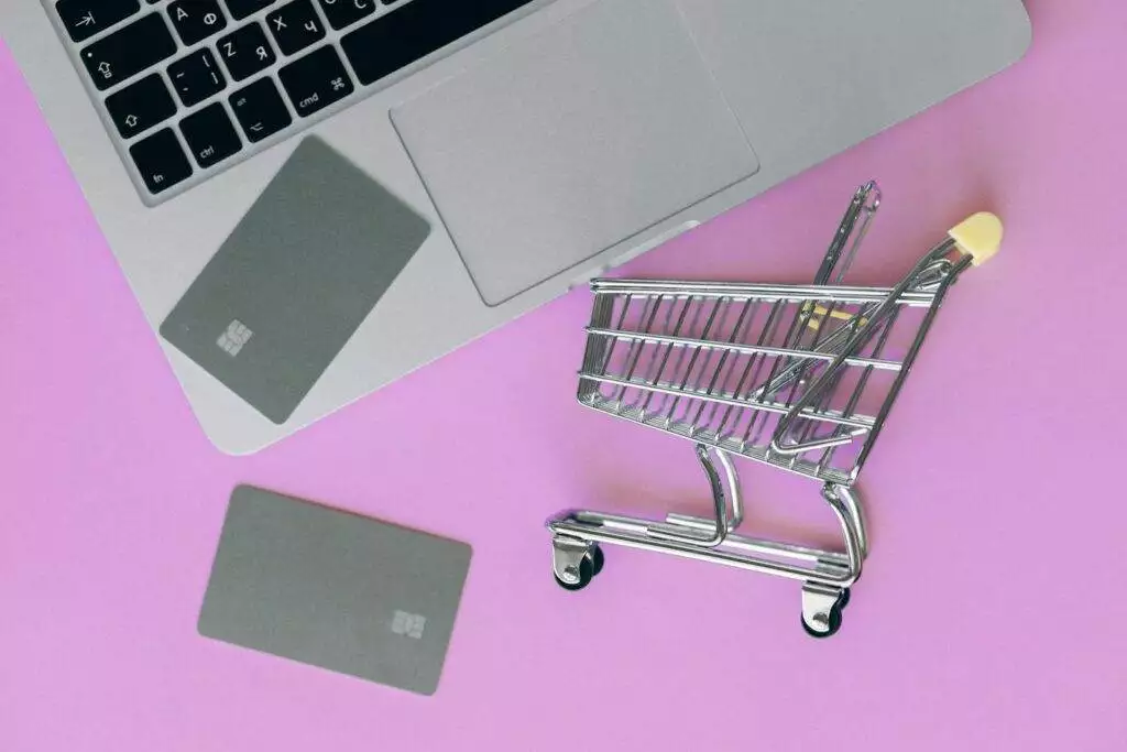 Ecommerce Business Silver Shopping Cart On Pink Surface 