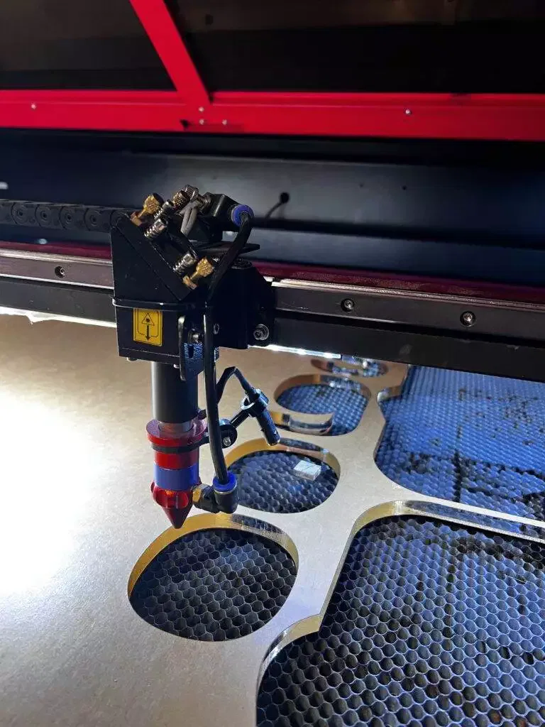 Technician Operating Laser Cutting And Engraving Machine